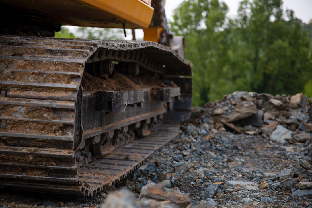A U.S. Airman operates a crawler excavator to extract dirt during Innovative Training Readiness, Stonewall State Park, West Virginia, July 25, 2024. The mission of IRT is to produce mission-ready forces through military training opportunities that provide services for American communities. (U.S. Marine Corps photo by Lance Cpl. Kanoa Thomas)