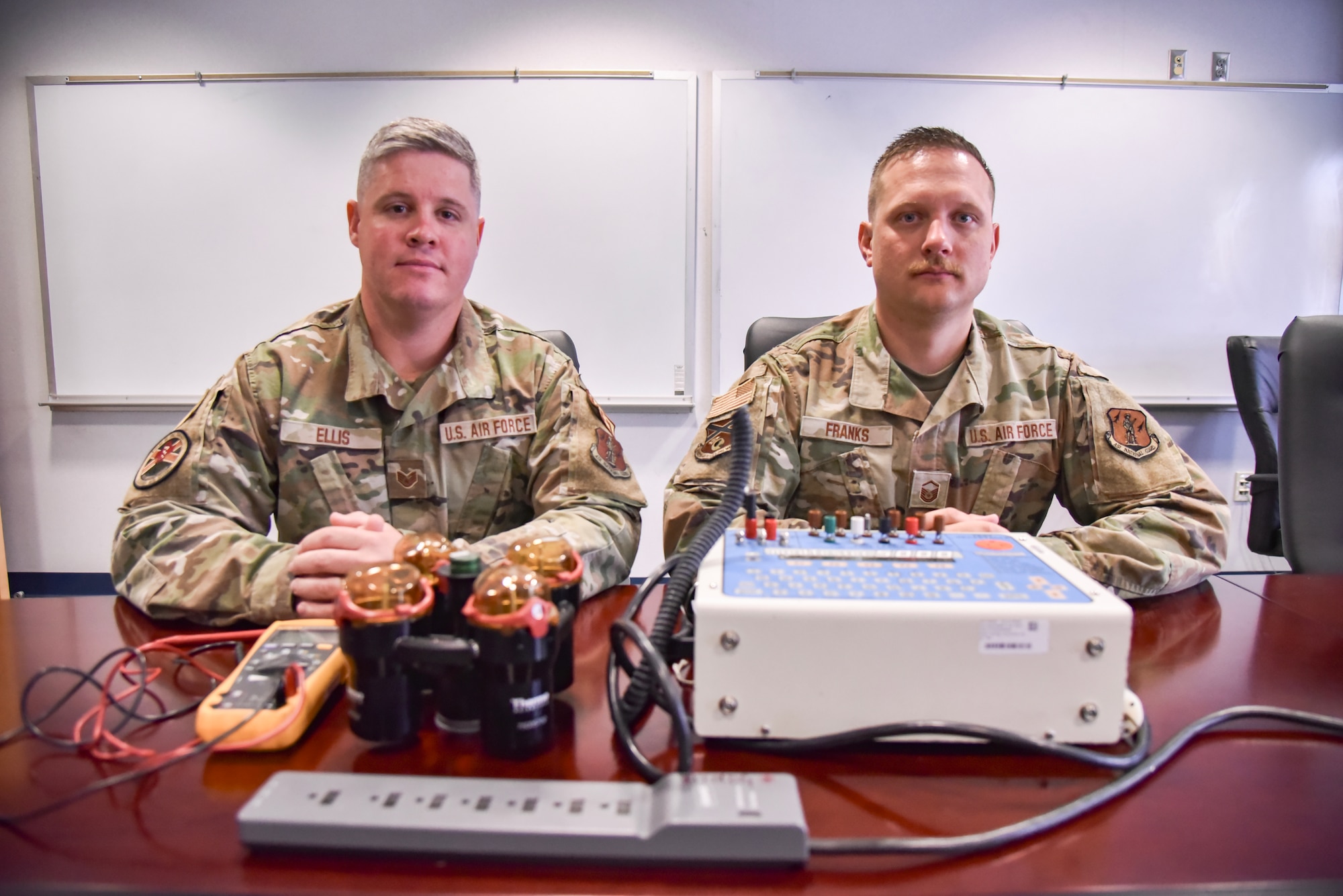 Biomedical Equipment Technicians from the 117th Medical Group pose in front of medical devices.