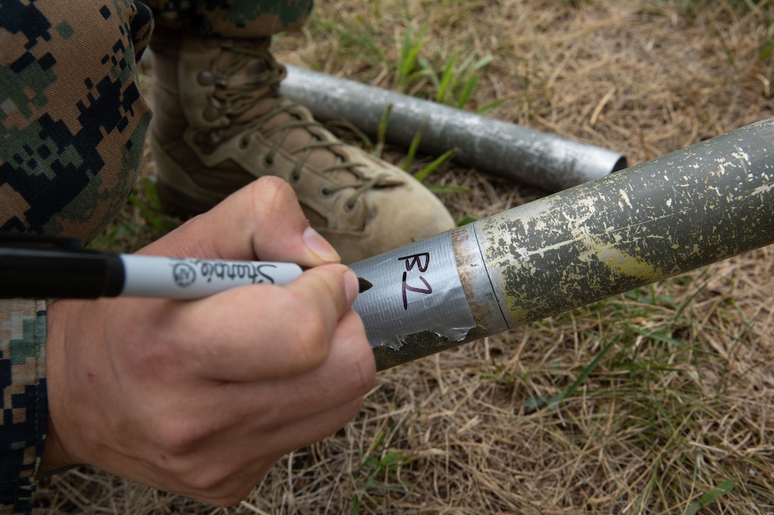 A U.S. Marine with Service Company, 6th Communication Battalion, Force Headquarters Group, Marine Forces Reserve, marks a communication antenna during Innovative Readiness Training, Stonewall State Park, West Virginia, July 24, 2024. The IRT program allows service members to engage with communities by performing civil projects, increasing military occupational specialty proficiency and readiness.  (U.S. Marine Corps photo by Lance Cpl. Kanoa Thomas)