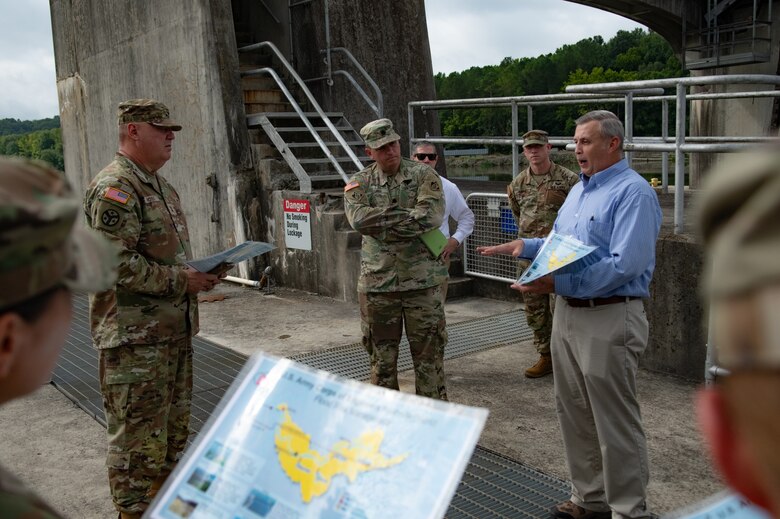 Tim Dunn, deputy chief of operations with the U.S. Army Corps of Engineers Nashville District, briefs Maj. Gen. Warner Ross II, second from left, adjutant general of the Tennessee National Guard, on the USACE locks and dams in the Cumberland River Basin at Cheatham Lock and Dam in Ashland City, Tennessee, July 29, 2024. (USACE Photo by Jeremy Croft)