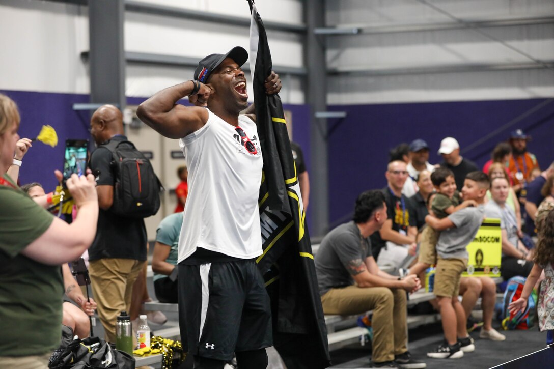U.S. Army Staff Sgt. Derrick Thompson flexes for the “flex cam” at the powerlifting event during the 2024 Department of Defense Warrior Games