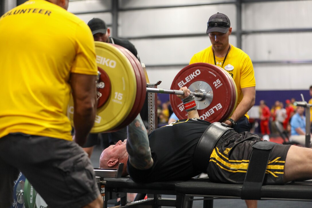 U.S. Army veteran Steven Bortle executes a clean lift in the powerlifting competition during the 2024 Department of Defense Warrior Games