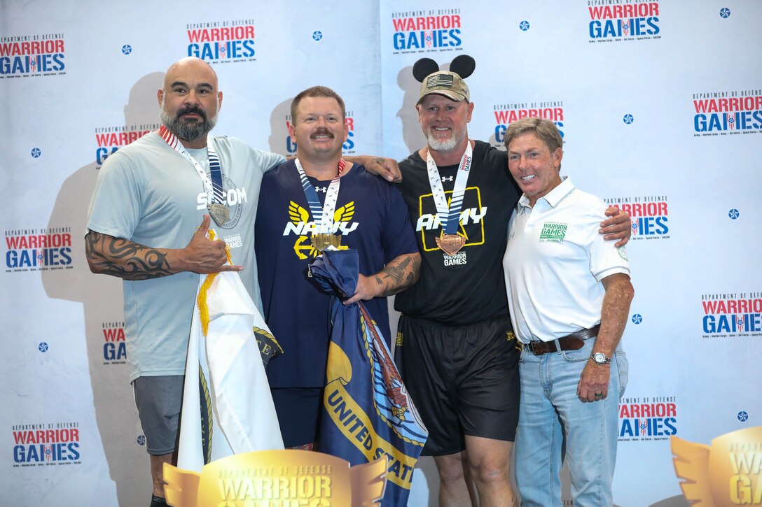 U.S. Army veteran Steven Bortle, second from right, (bronze medal winner for his class), poses with fellow medalists from other services at the powerlifting competition during the 2024 Department of Defense Warrior Games