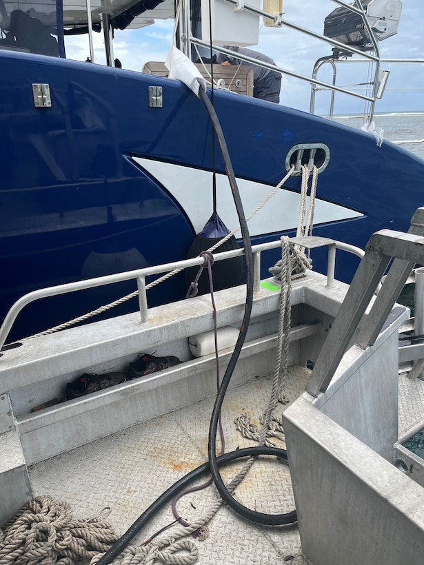 Photo showing transfer hose used by Resolve Marine and Clean Harbors personnel to recover fuel from the grounded sailing vessel catamaran Obsession July 31, 2024, just off Flamenco Beach in Culebra, Puerto Rico.  The Coast Guard established and Incident Command with local and federal interagency partners, July 26, 2024, to oversee the removal of an estimated 800 to 1,500 gallons of diesel from the vessel as well as the engine oil and any potential hazardous materials onboard. (Courtesy photo)