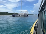 Photo showing fuel removal operations aboard the 72-foot sailing vessel Obsession hard aground on a reef just off Flamenco Beach in Culebra, Puerto Rico, July 31, 2024.  The Coast Guard established and Incident Command with local and federal interagency partners, July 26, 2024, to oversee the removal of an estimated 800 to 1,500 gallons of diesel from the vessel as well as the engine oil and any potential hazardous materials onboard. (Courtesy photo)