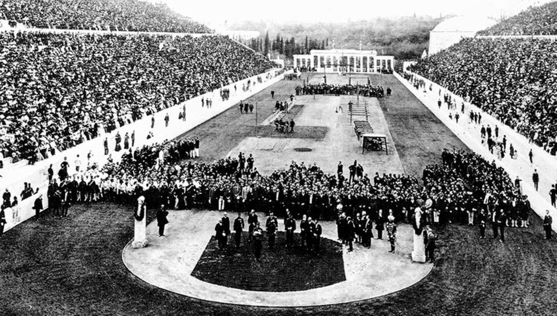 Wide angle photo of the stadium showing the crowds and the ceremony at the center.