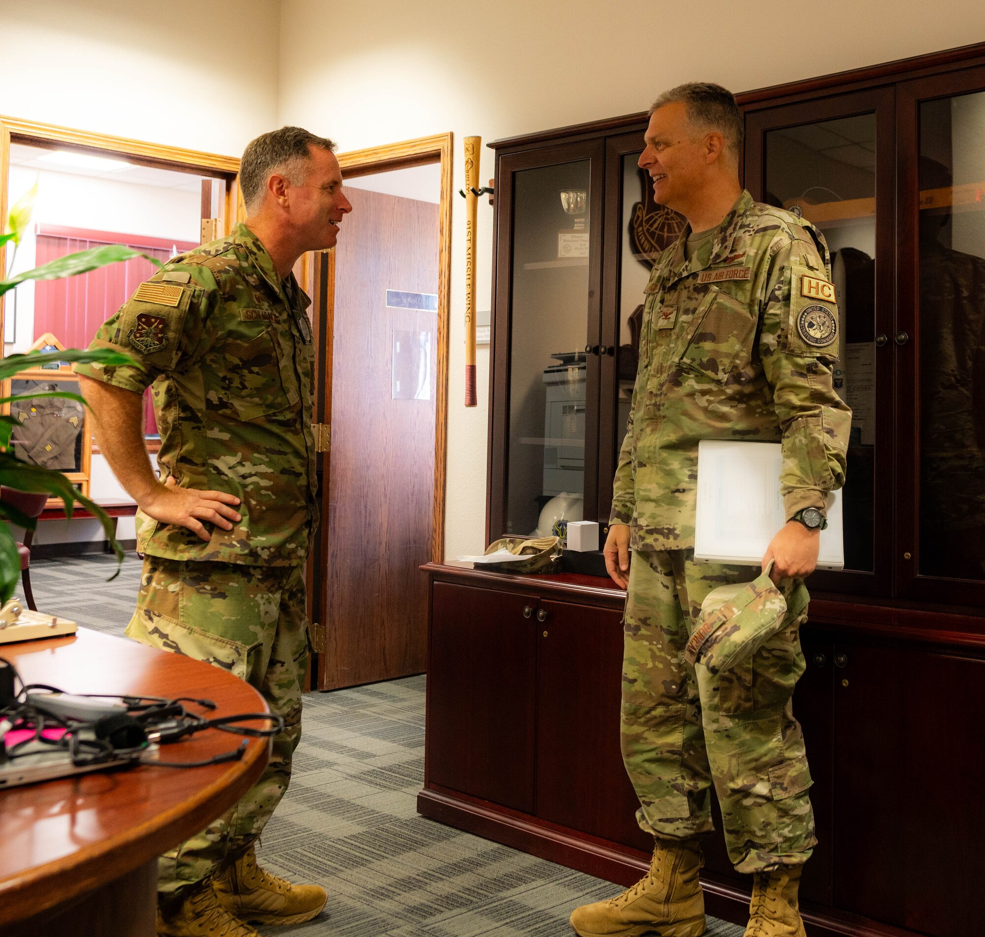 U.S. Air Force Col. Darren Duncan, U.S. Strategic Command command chaplain (right), is greeted by U.S. Air Force Col. James Schlabach, 5th Bomb Wing commander, at Minot Air Force Base, North Dakota, July 31, 2024. The two leaders discussed ongoing initiatives to support the spiritual resilience of Airmen stationed at Minot AFB, highlighting the importance of comprehensive wellness programs for mission readiness and overall well-being. (U.S. Air Force photo by Airman 1st Class Luis Gomez)