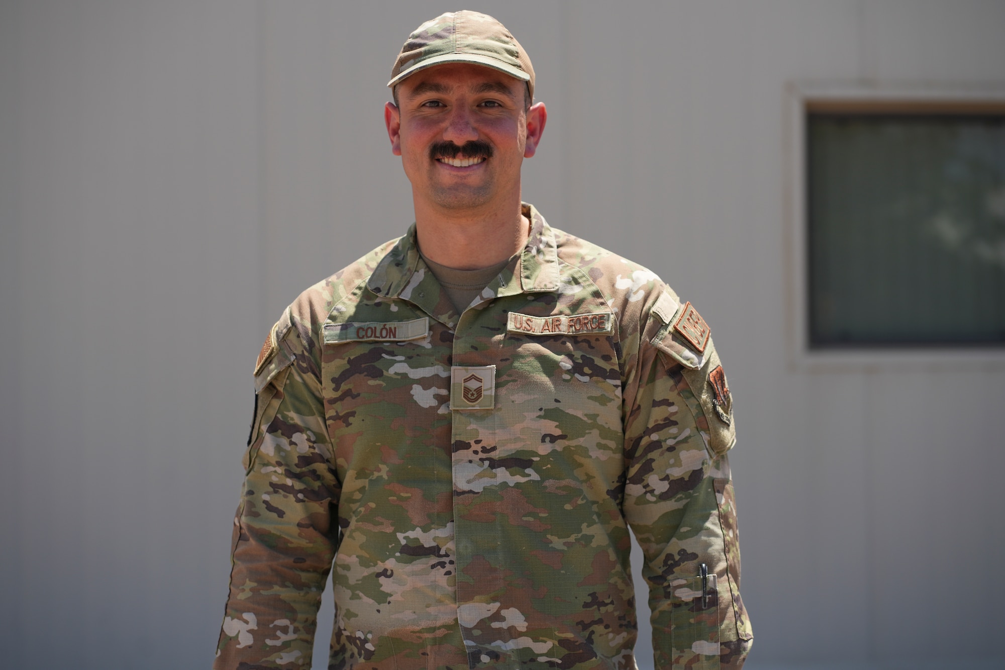 An airman stands for a portrait.