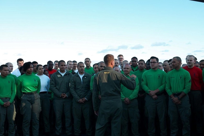 Lt. Col. Jeffrey Davis, commanding officer of Marine Fighter Attack Squadron 314, addresses Marines and Sailors of VMFA-314 aboard the flight deck of the Nimitz-class aircraft carrier USS Abraham Lincoln (CVN 72), July 20, 2024, while underway in the Pacific Ocean. VMFA 314, assigned to Carrier Air Wing 9 aboard the Lincoln, is underway conducting routine operations in the U.S. 7th Fleet area of operations. (U.S. Marine Corps courtesy photo)