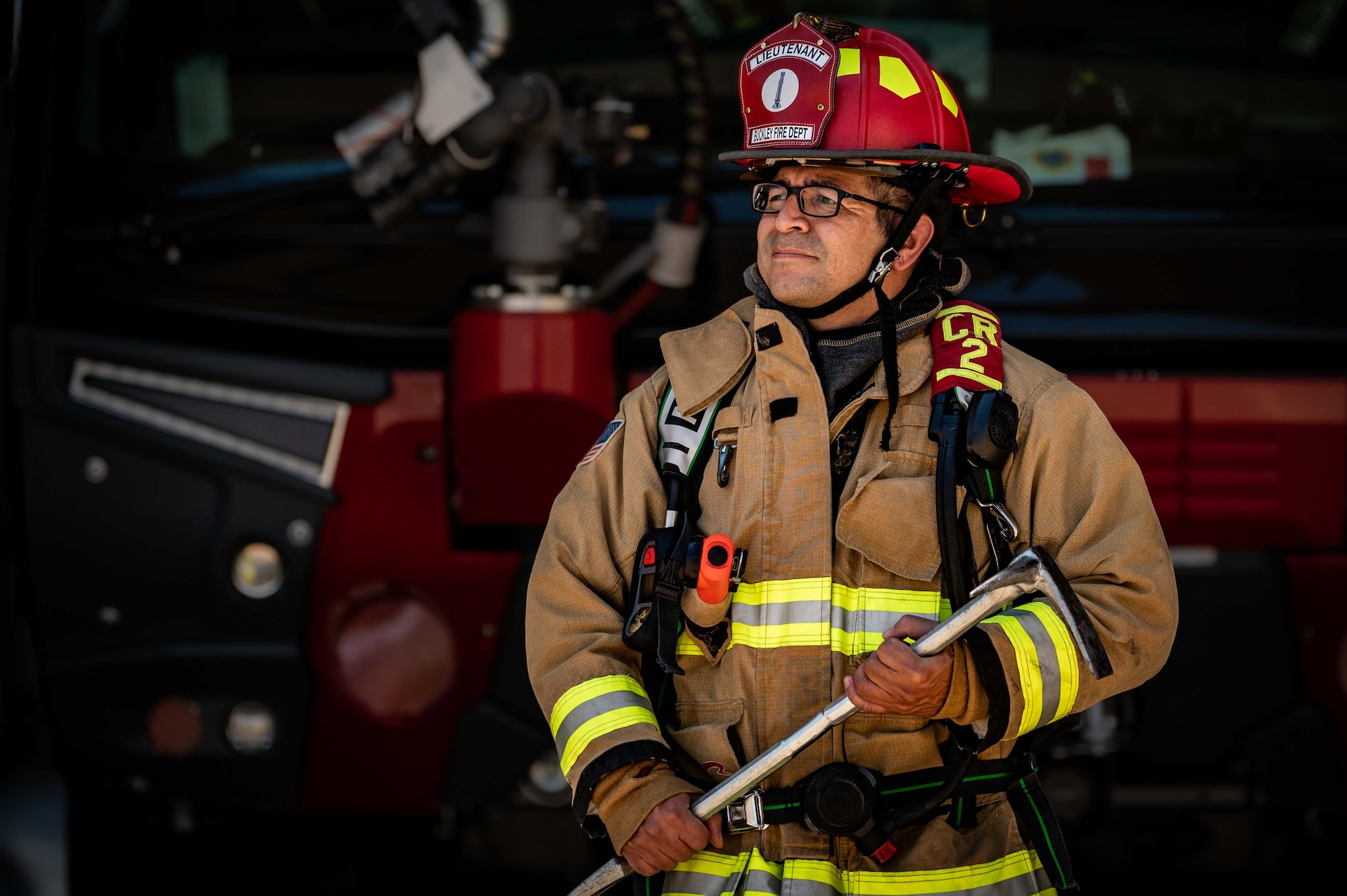 Man poses for photo in firefighter gear