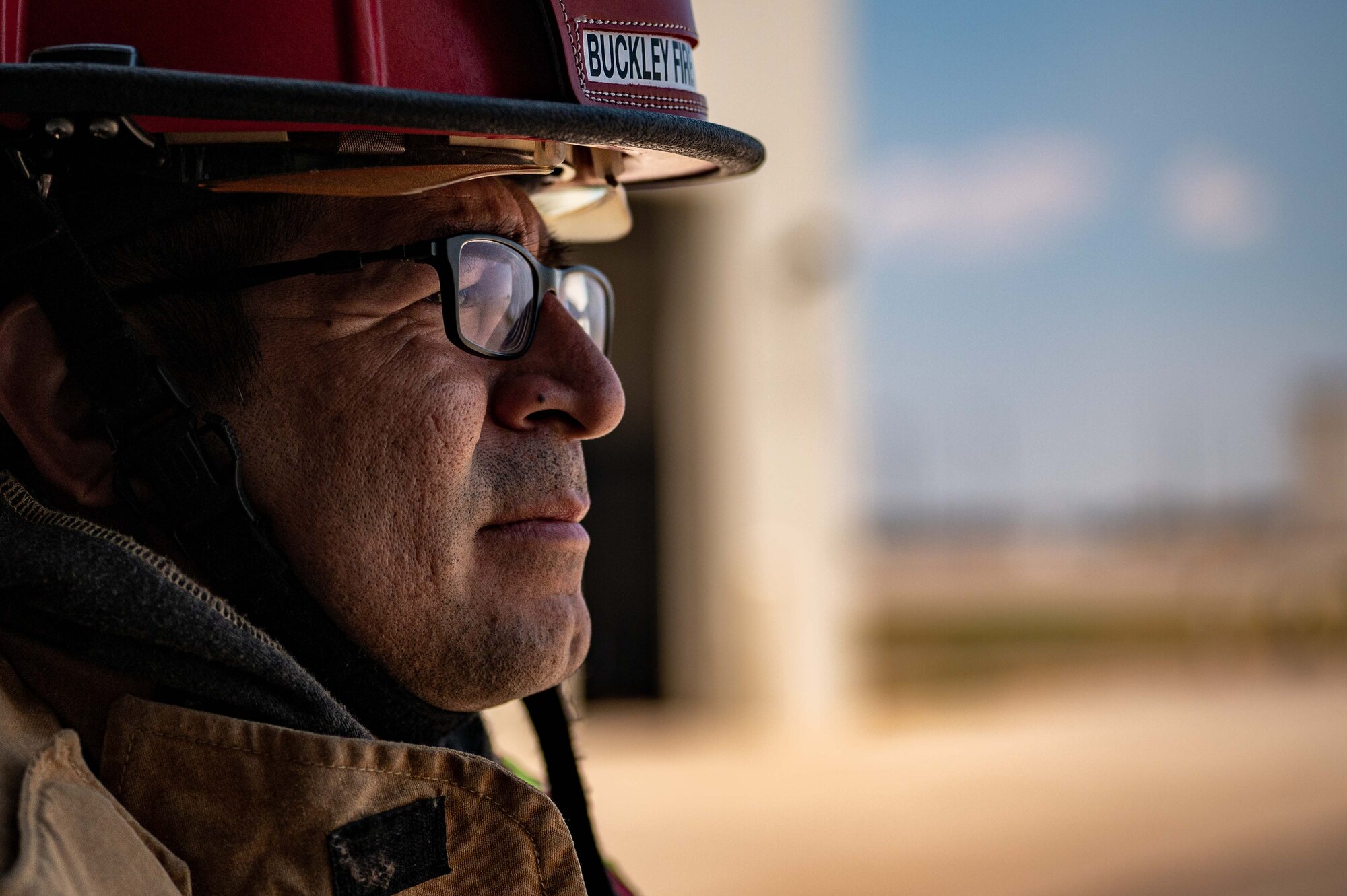 Man poses for photo in firefighter gear