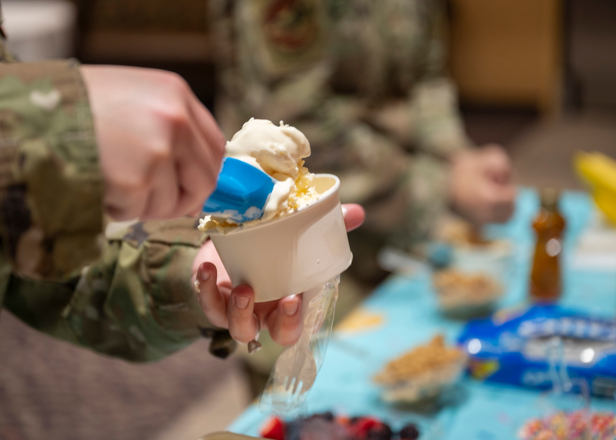 A U.S. Airman scoops ice cream during an ice cream social in the community center at Davis-Monthan Air Force Base, Ariz., July 31, 2024. The social served as a meet and greet between Airmen and True North representatives. (U.S. Air Force photo by Airman 1st Class William Finn V)