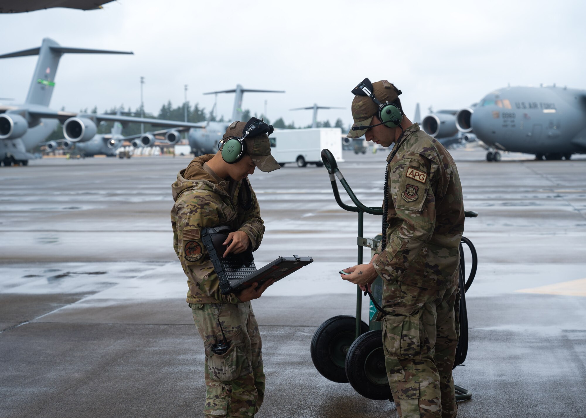 U.S. Air Force Airmen perform pre-flight checks at Joint Base Lewis-McChord, Washington, July 29, 2024. Crew chiefs from the 62d Aircraft Maintenance Squadron are responsible for many tasks including aircraft maintenance, inspections, repairs, and marshalling aircraft departing and arriving.