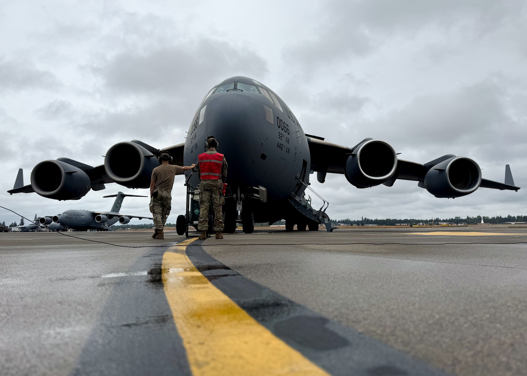 U.S. Air Force Airmen perform pre-flight checks at Joint Base Lewis-McChord, Washington, July 29, 2024. Crew chiefs from the 62d Aircraft Maintenance Squadron are responsible for many tasks including aircraft maintenance, inspections, repairs, and marshalling aircraft departing and arriving.