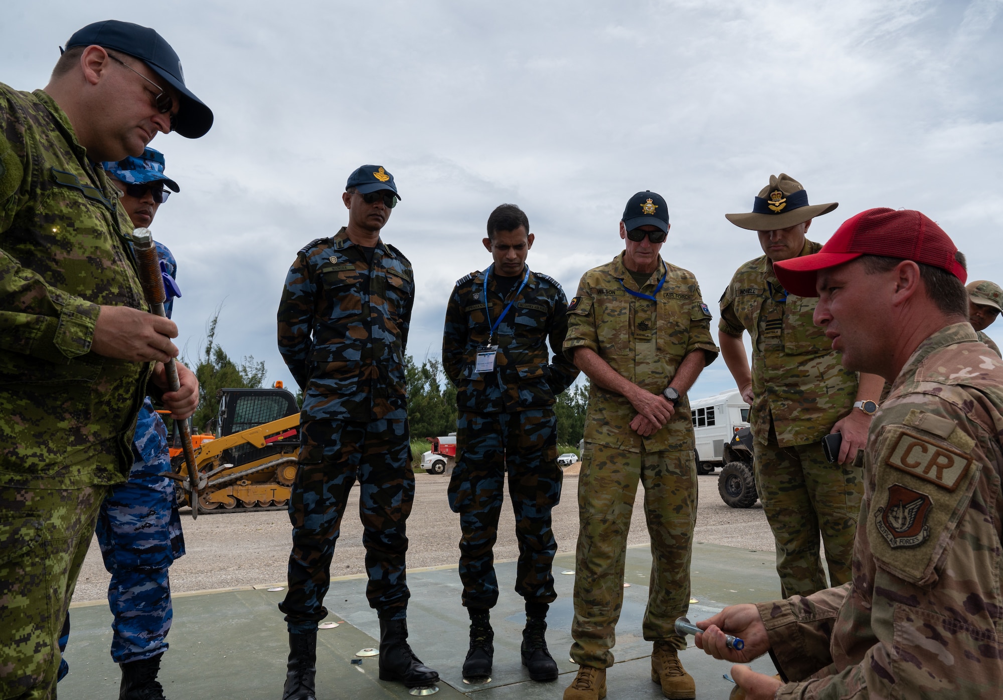 Visiting foreign Key Leaders receive a briefing from a U.S. Air Force 554th Rapid Rapid Engineer Deployable Heavy Operational Repair Squadron Engineer cadre Pacific Regional Training Center-Andersen, Guam, July 26, 2024. The briefing was a showcase of fiber reinforced polymer matting, the cutting edge matting the Air Force uses for crater repair. (U.S. Air Force photo by Airmen 1st Class Manasseh Demissie)