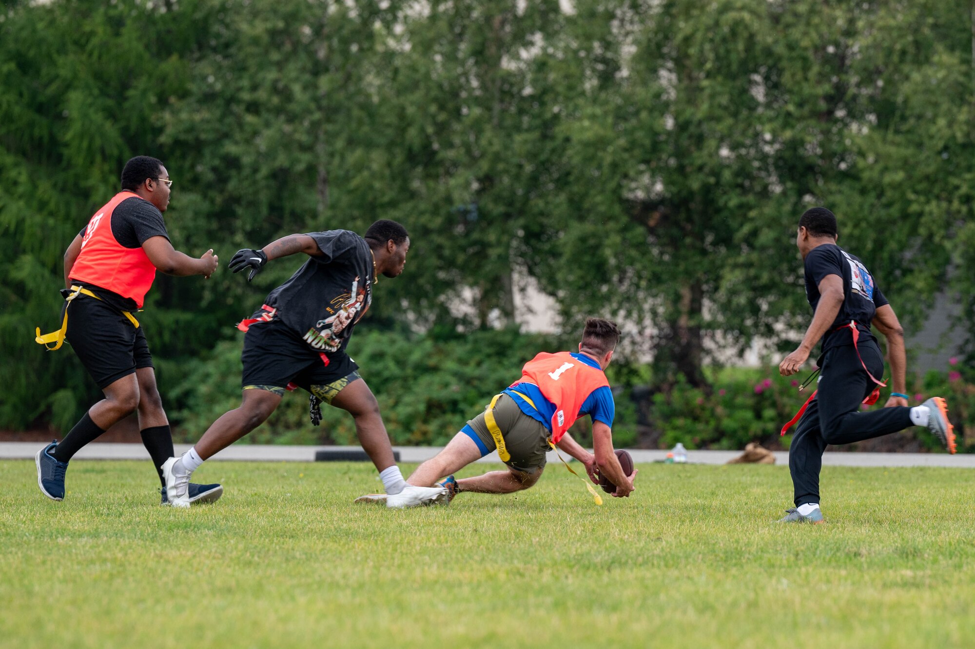 U.S. Air Force 2nd Lt. Colten Riley, 354th Comptroller Squadron financial services officer in charge, completes a diving catch during a flag football competition