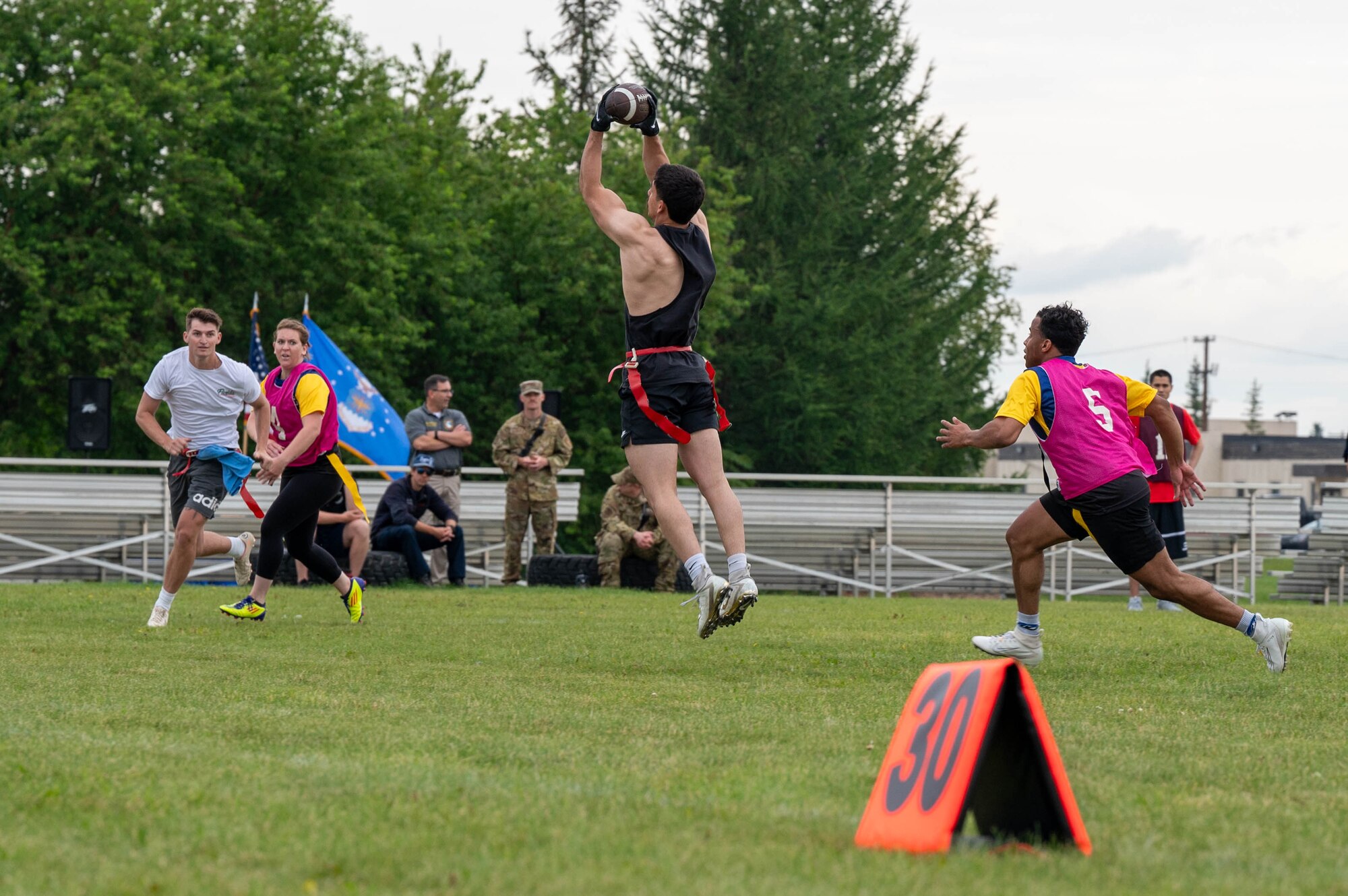 U.S. Air Force Senior Airman Steven Fuerte, 354th Munitions Squadron stockpile management technician, completes a catch during a flag football competition