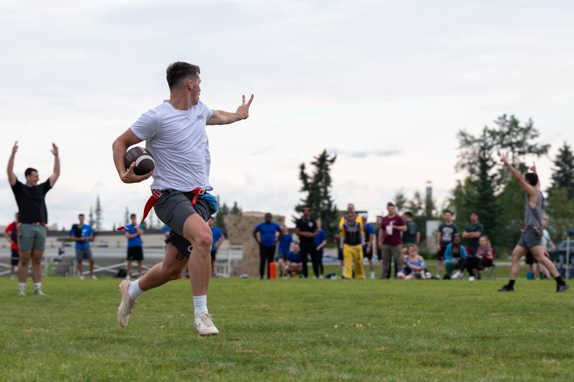 U.S. Air Force Airman 1st Class Mason Urich, 354th Munitions Squadron stockpile management technician, runs for a touchdown during a flag football competition