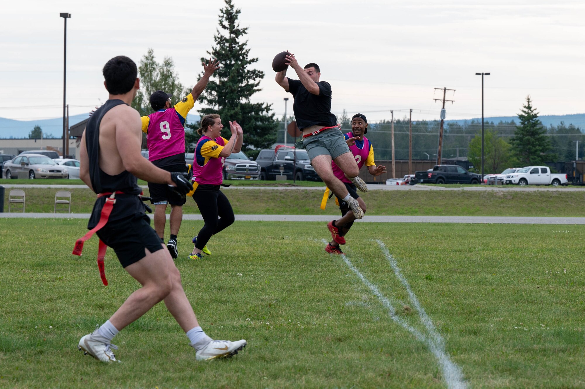 U.S. Air Force Airman Ethan Theriot, 354th Munitions Squadron stockpile management technician, completes a pass for a touchdown during a flag football competition
