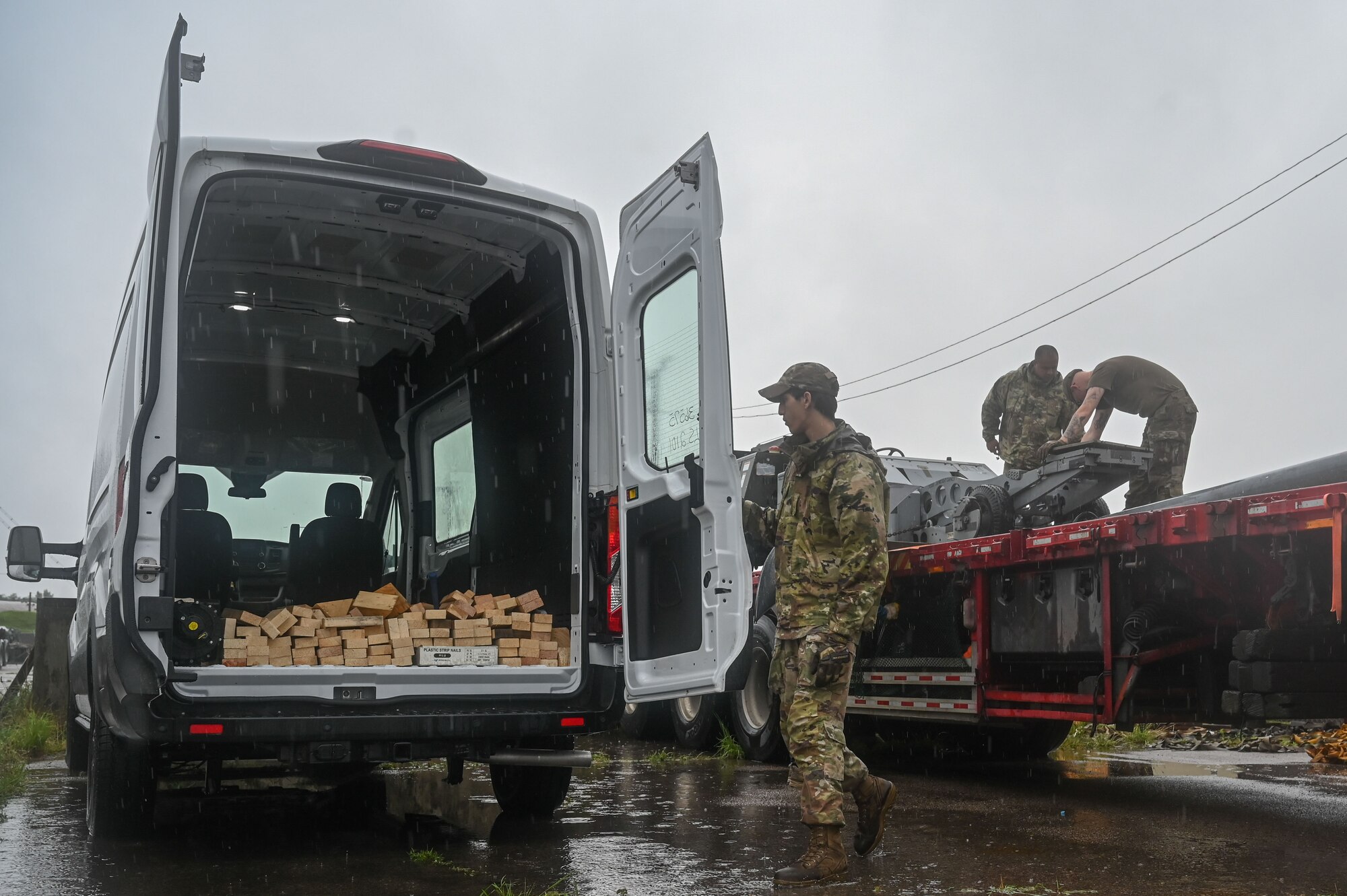 Senior Airman Ryan Cimino, left, 8th Logistics Readiness Squadron inbound cargo technician, Staff Sgt. Dylan Tusano, middle, 8th LRS noncommissioned officer in charge of inbound cargo, and Senior Airman Johnathon Clark, right, 8th LRS packing and crating supervisor, load maintenance supplies into a vehicle during a cargo deployment function.