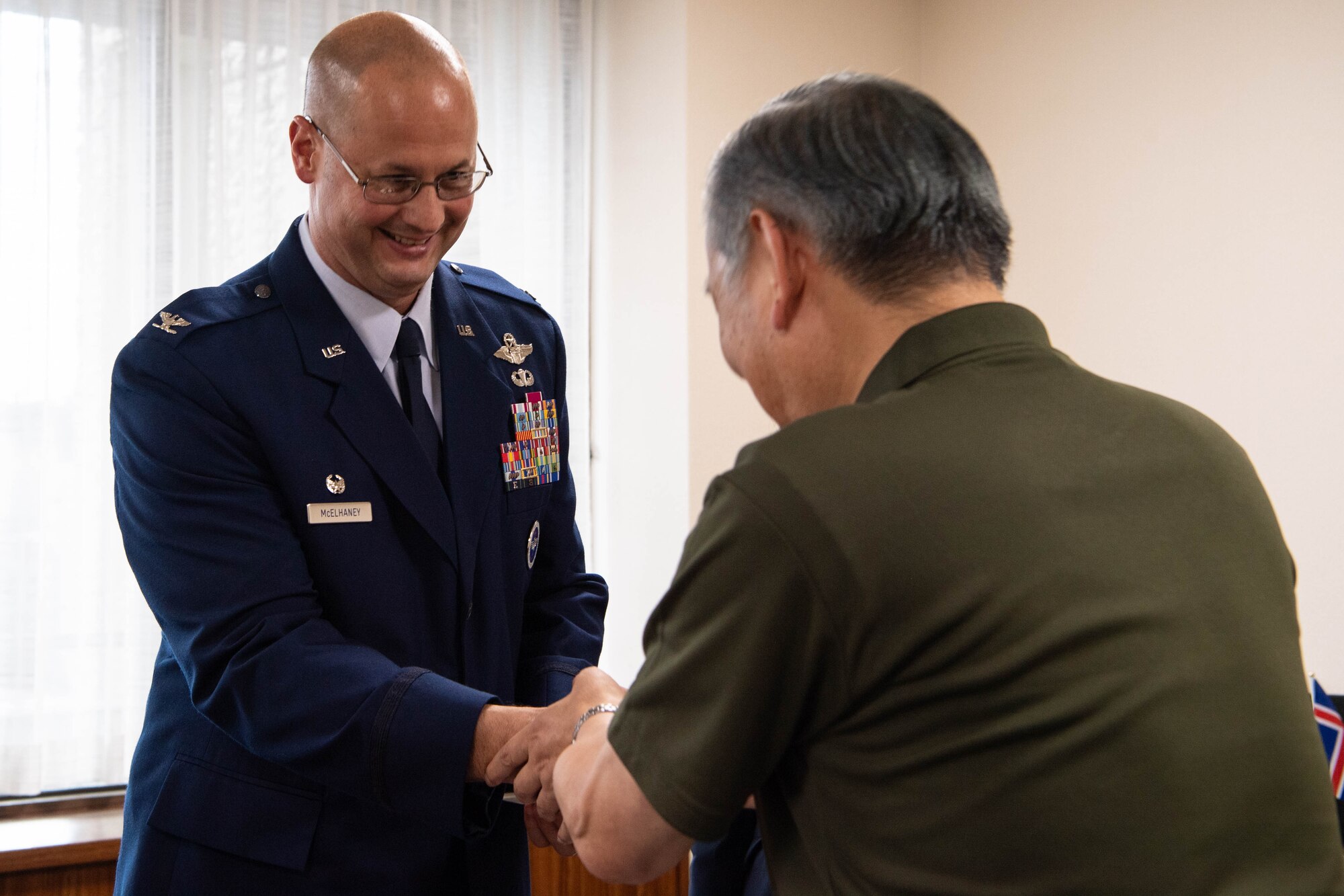 Two people shake hands.