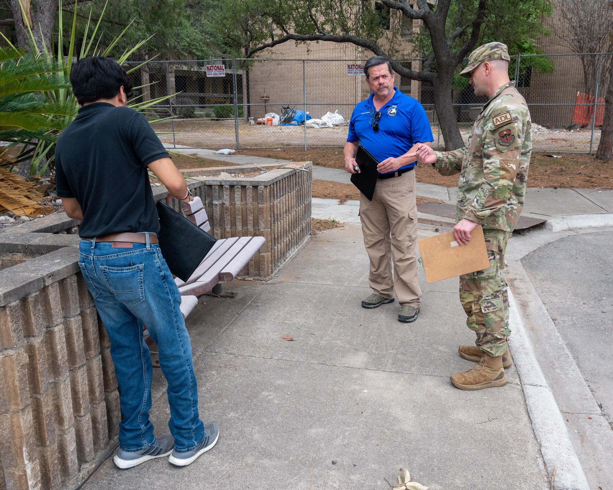 Anthony Martinez, center, 47th Flying Training Wing (FTW) occupational safety and health specialist, and Noah Montelongo, left, 47th FTW safety intern, speaks with Tech. Sgt. Keith Martincic 47th Civil Engineer Squadron dorm manager, about a broken bench at Laughlin Air Force Base, Texas, June 5, 2024. During inspections, the safety office identifies and notes down possible hazards for airmen, directing them to be fixed. (U.S. Air Force photo by Staff Sgt. Nicholas Larsen)