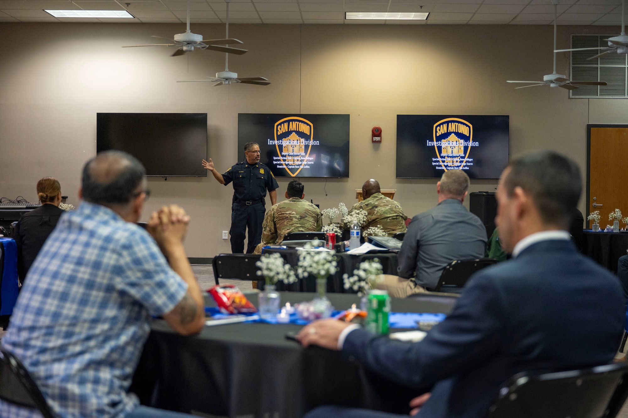 Capt. Rene Gallegos, San Antonio Police Department Special Victims Unit Investigator, addresses a room of law enforcement officers from the community during a luncheon at Joint Base San Antonio-Fort Sam Houston, July 30, 2024. The event served as a meet and greet for all attending, allowing them to build camaraderie between agencies, and served as a platform to introduce training opportunities to help each other in becoming more successful law enforcement units. (U.S. Air Force photo by Taylor Curry)