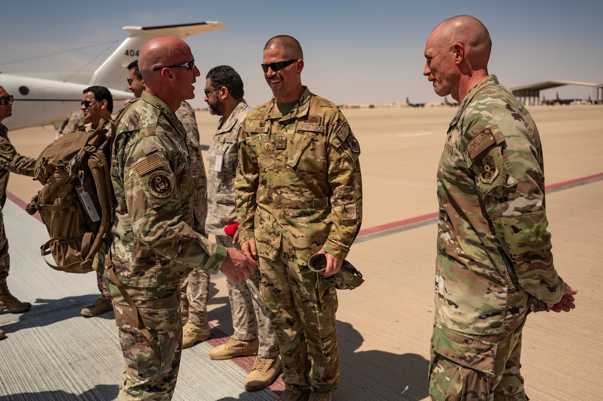 Chief Master Sgt. of the Air Force David Flosi is greeted by Col. Seth Spanier, 378th Air Expeditionary Wing commander, and Chief Master Sgt. Benjamin McCullough, 378th AEW command chief, at an undisclosed location within the U.S. Central Command area of responsibility, July 23, 2024. During his historic first visit, Flosi spoke about the significance of further developing Airmen alongside the new Air Task Force model to increase overall mission readiness. (U.S. Air Force photo)