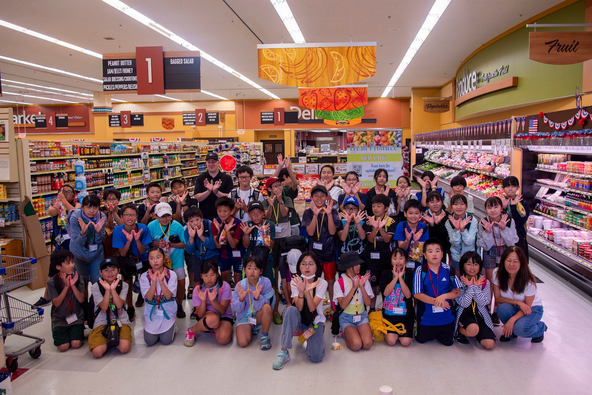 Towada Elementary School students and Misawa Commissary members pose for a photo after completing a Junior English tour at Misawa Air Base, Japan, July 23, 2024.