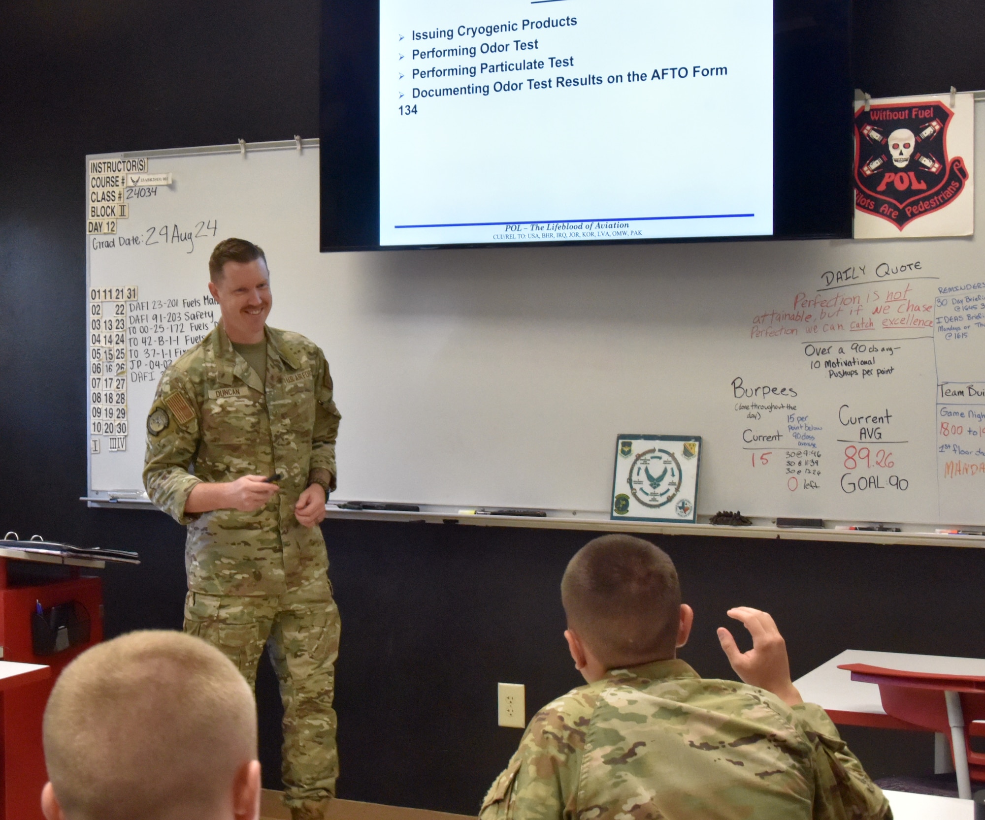 An Airman stands in front of a class