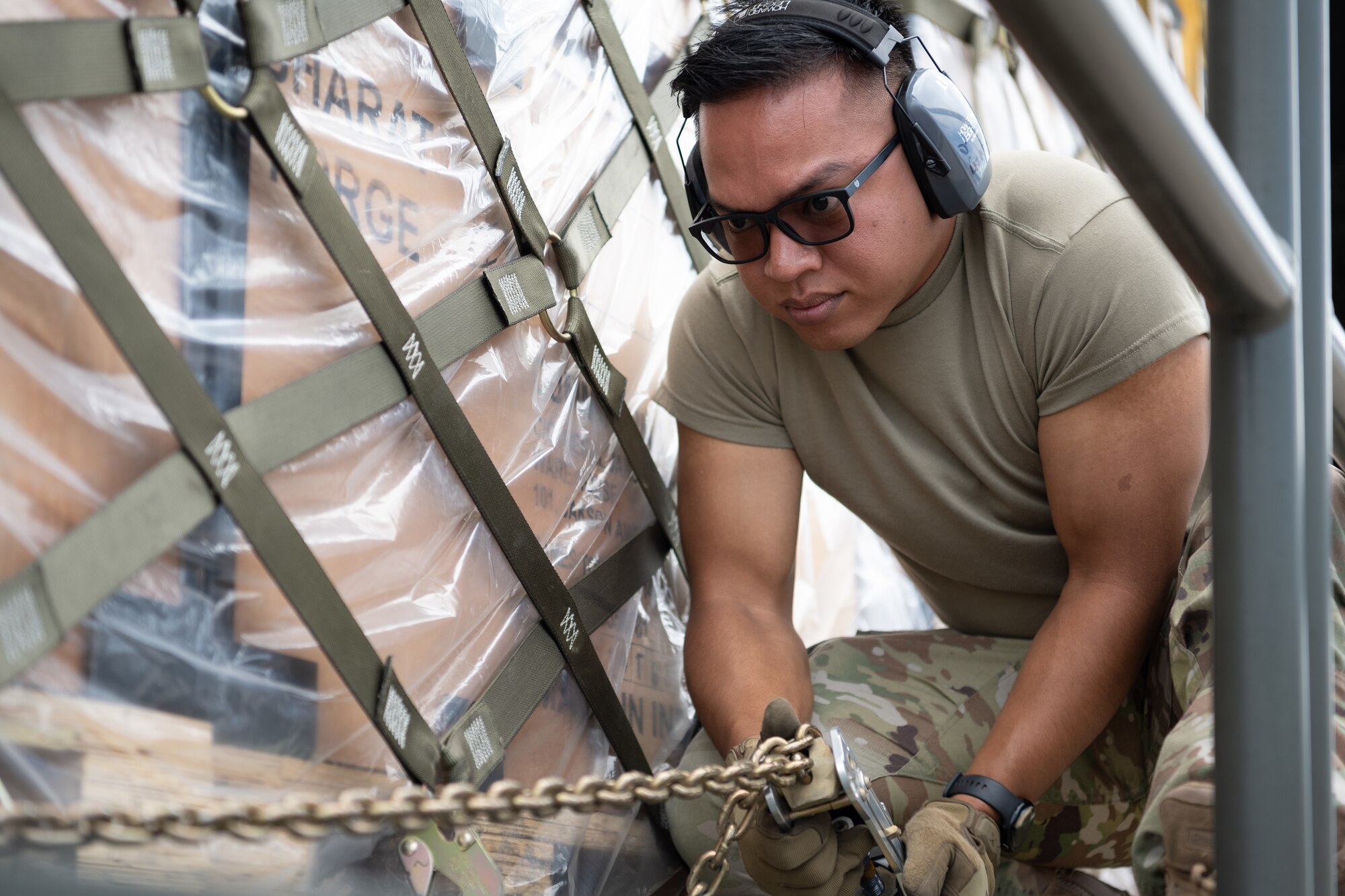 airman secures cargo on a k-loader