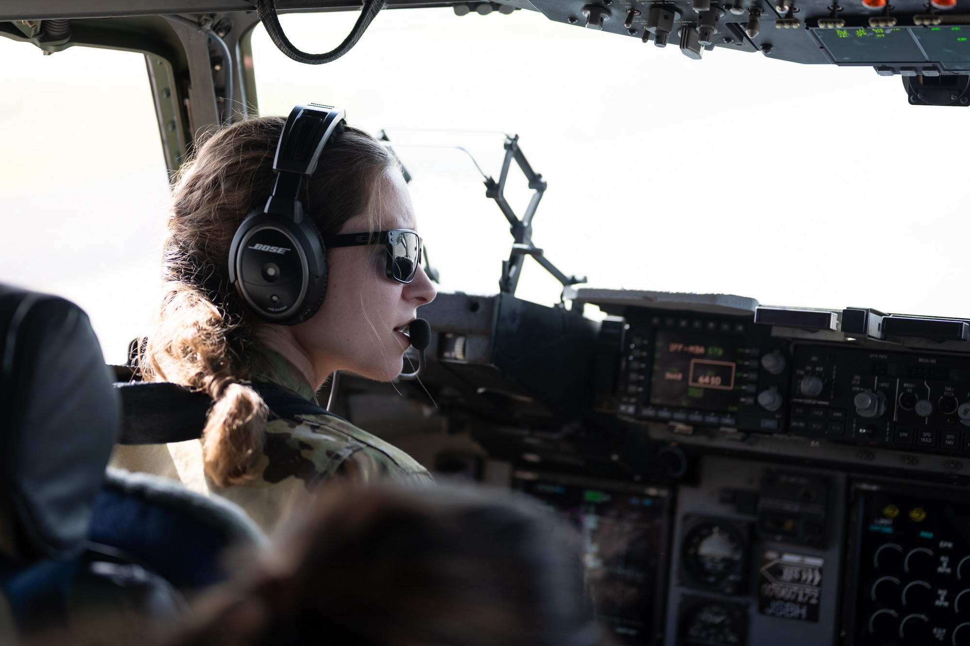 a photo of a female pilot in a flight deck