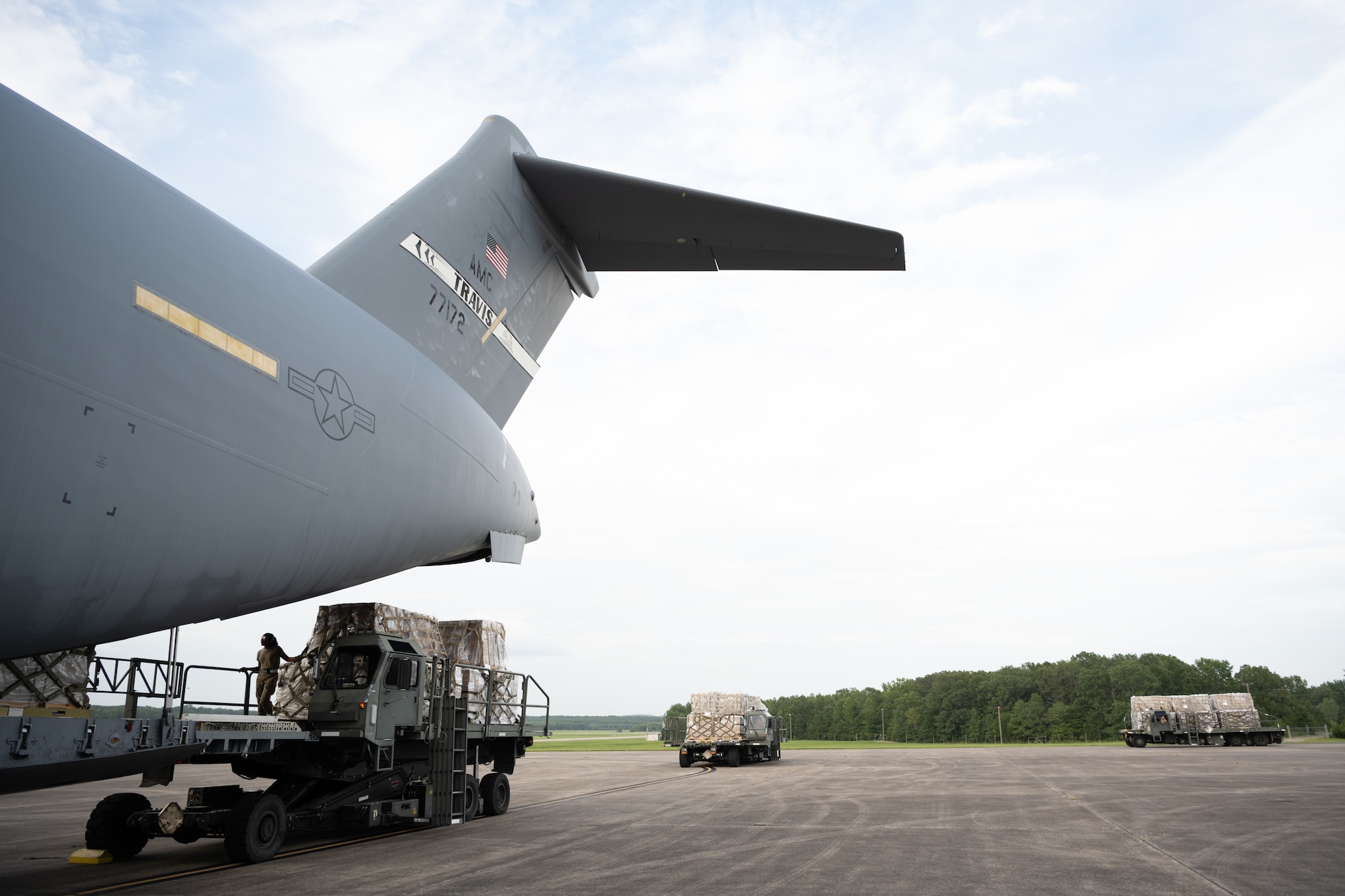 Airmen loading cargo to an aircraft