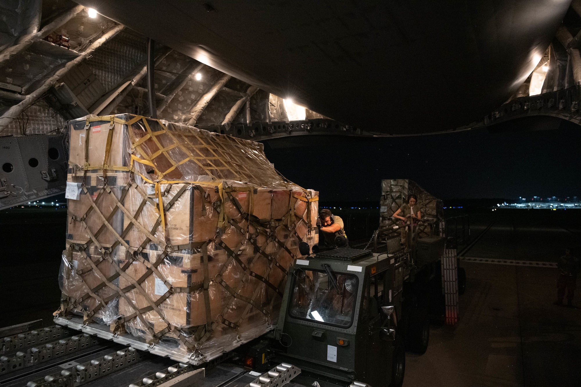 Airmen pushing cargo
