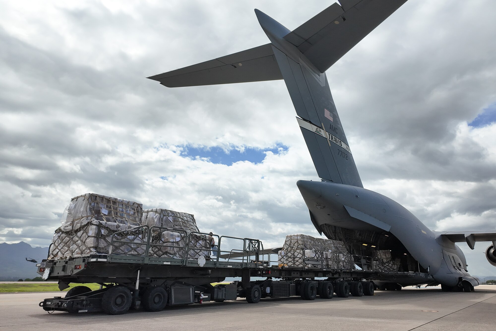 Airmen unloading cargo from an aircraft