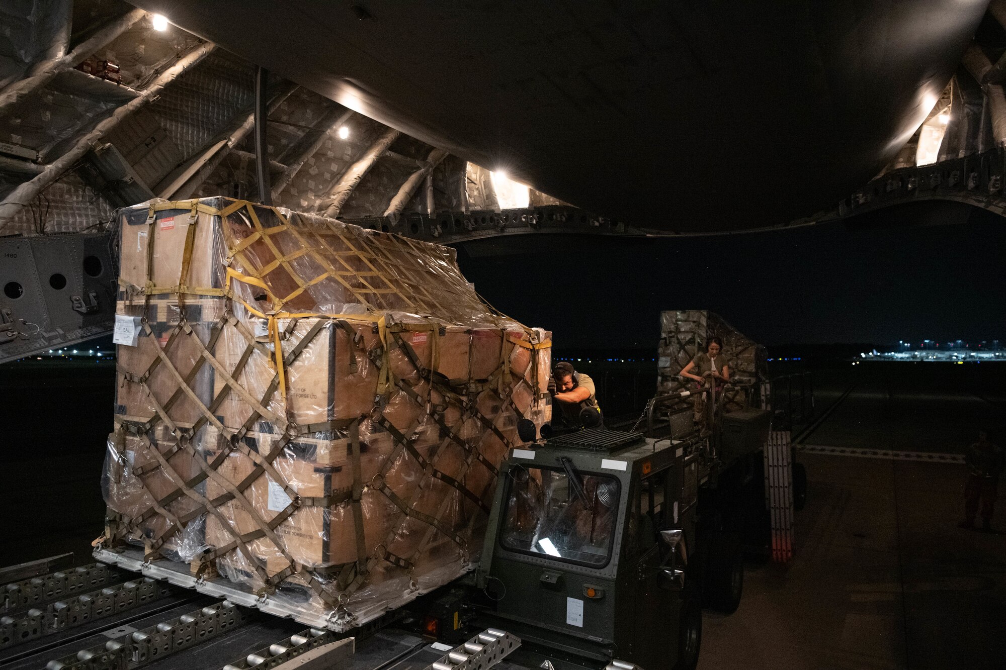 Airmen pushing cargo