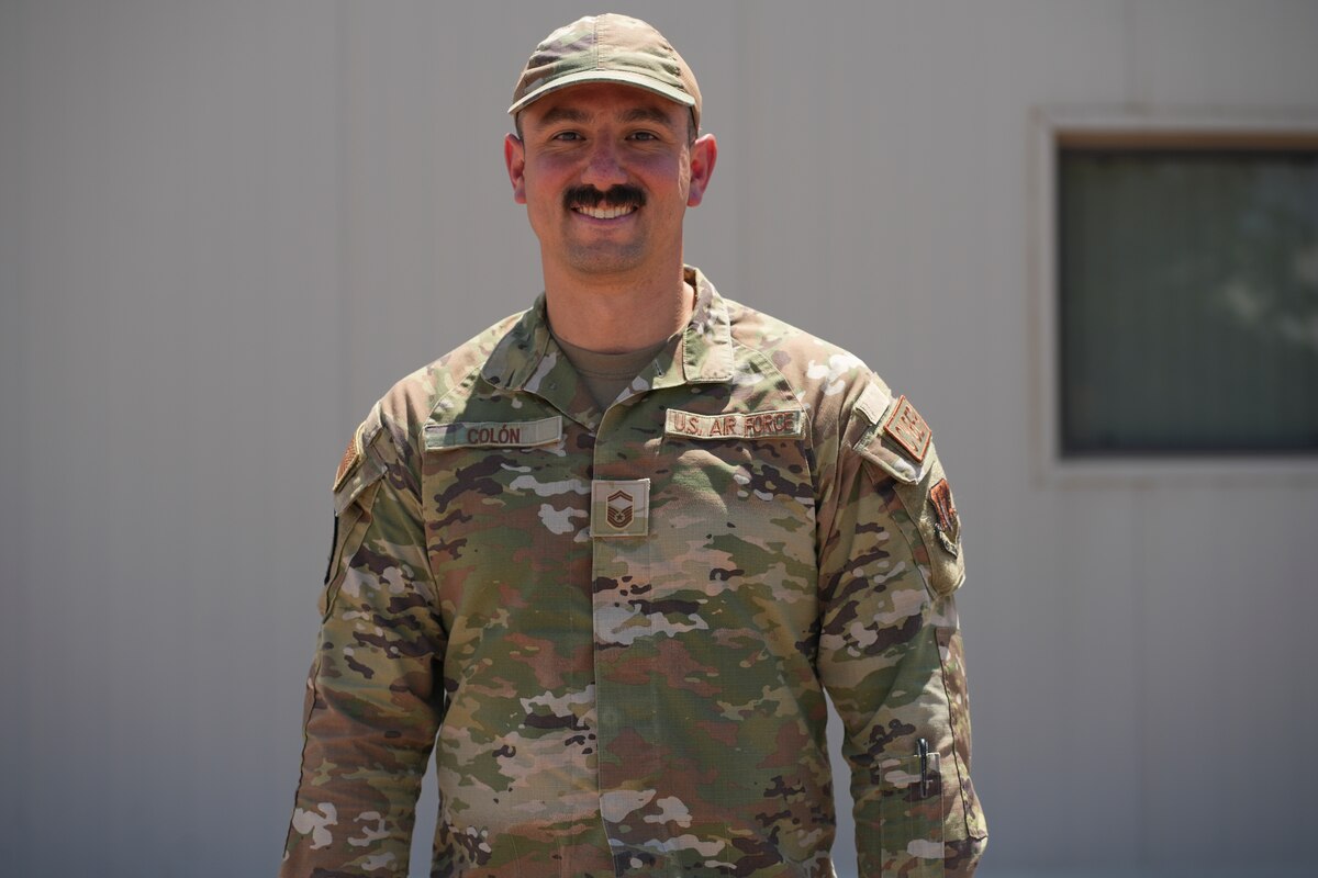An airman stands for a portrait.