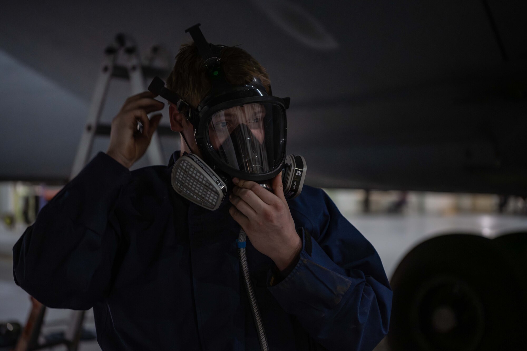 An aircraft fuels system mechanic assigned to the 3379th Expeditionary Maintenance Squadron dons a respirator at an undisclosed location within the U.S. Central Command area of responsibility, July 26, 2024.