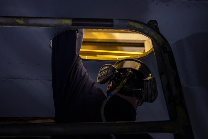 An aircraft fuels system mechanic assigned to the 379th Expeditionary Maintenance Squadron climbs into a fuel tank inside a KC-135 Stratotanker at an undisclosed location within the U.S. Central Command area of responsibility, July 26, 2024.