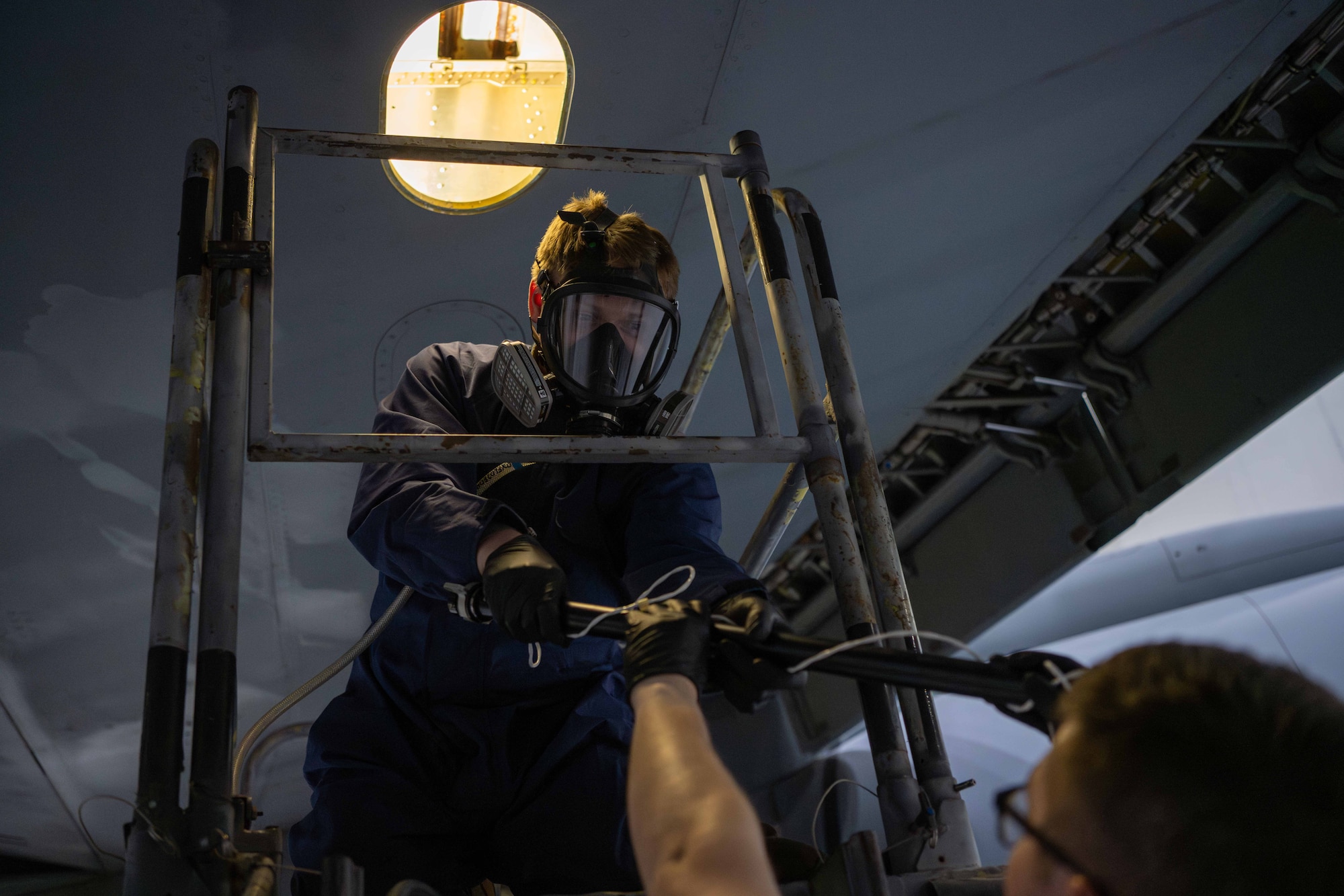 An aircraft fuels system specialist assigned to the 379th Expeditionary Maintenance Squadron receives a fuel probe at an undisclosed location within the U.S. Central Command area of responsibility, July 26, 2024.