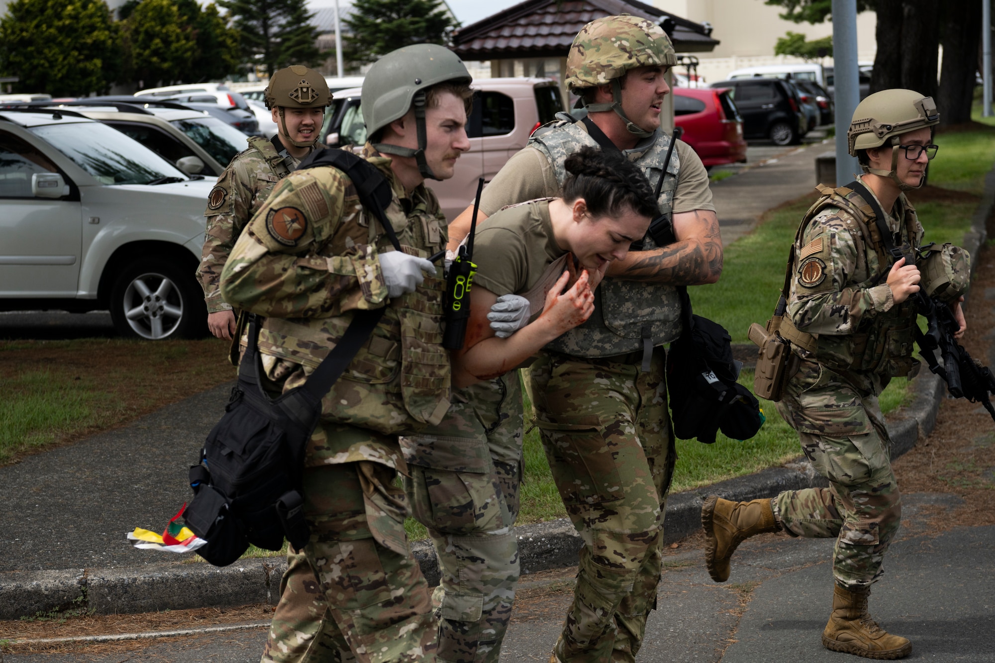 U.S. Airmen with the 35th Civil Engineer Squadron and 35th Security Forces Squadron conduct a casualty collection scenario during an active shooter exercise at Misawa Air Base, Japan, Aug. 1, 2024.