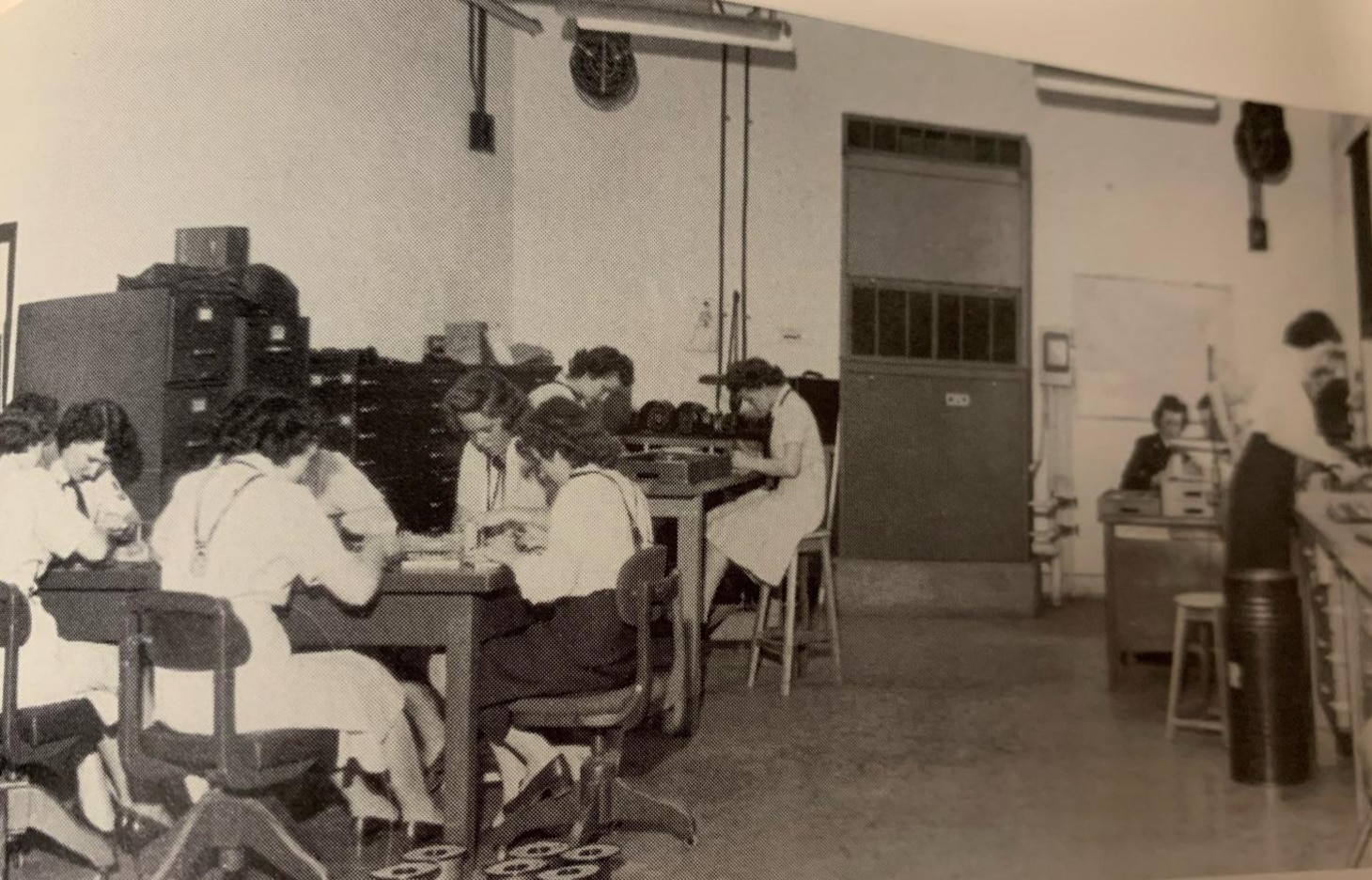 WAVES work on the commutator wheels used on the U.S. Navy Bombes (see wheels on the floor), 1943–45. Each cryptanalytic Bombe machine had 64 brass-and-copper wheels, with 104 electrical contact points per wheel that had to be wired and soldered by hand.