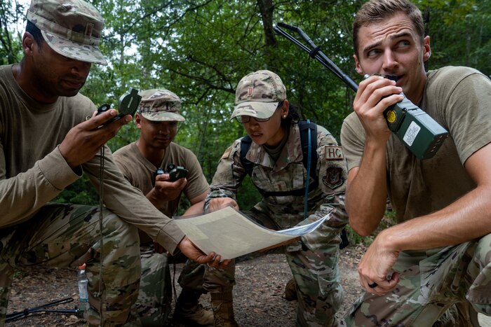 A group of Airmen practice land navigation tactics