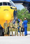 U.S. Navy personnel prepare to board the iconic "Fat Albert" C-130.