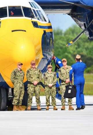 U.S. Navy personnel prepare to board the iconic "Fat Albert" C-130.