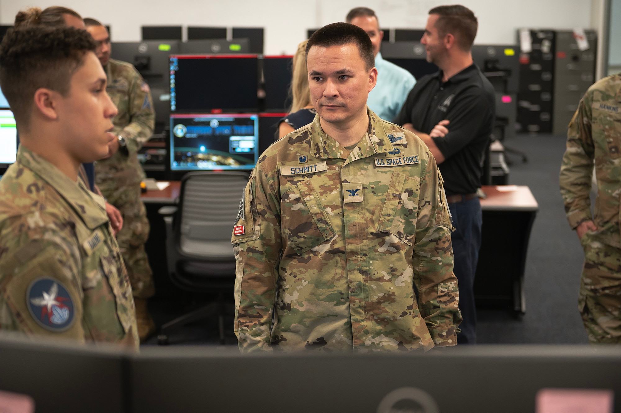 Two military members talk to each other.