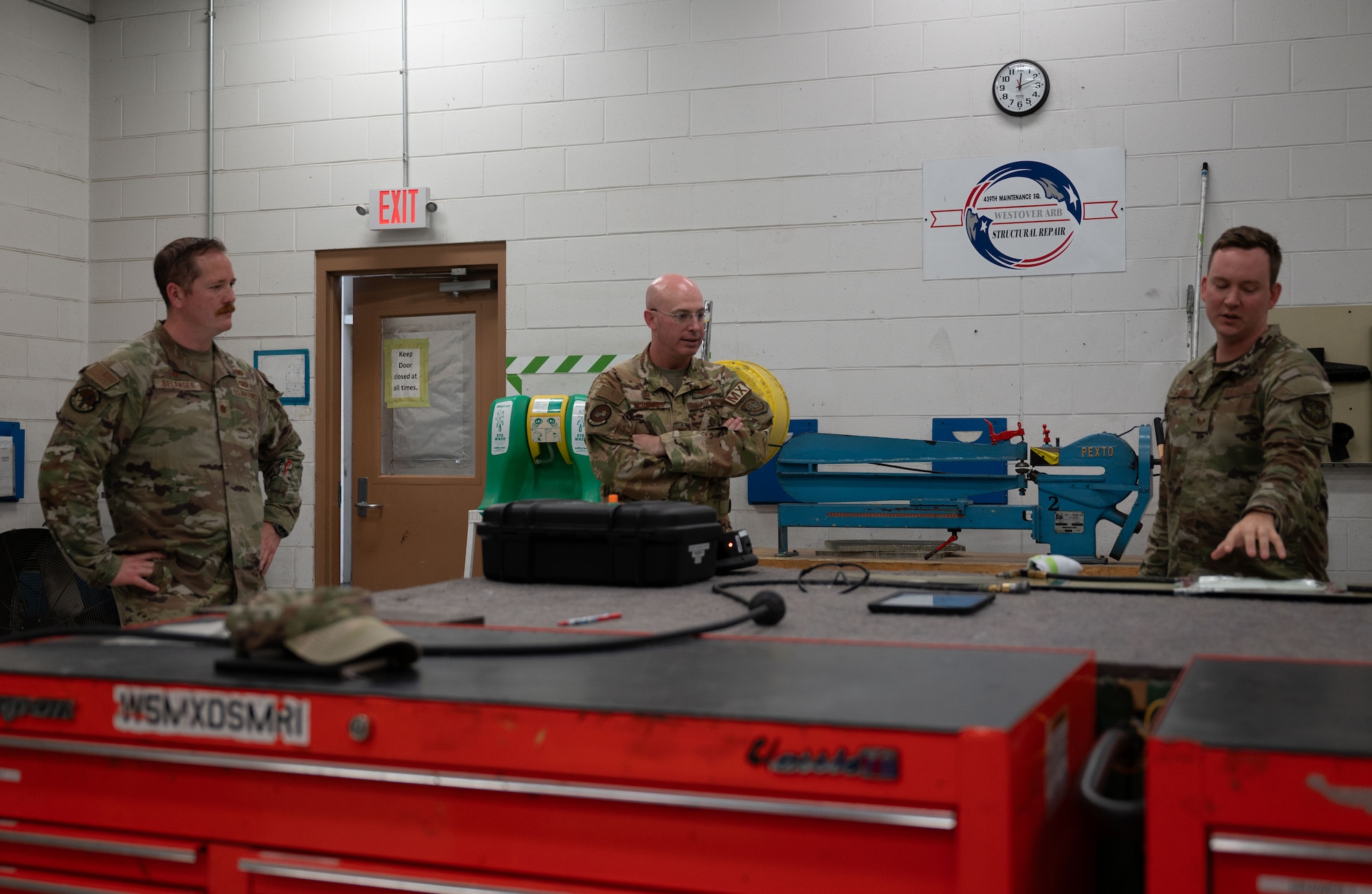 U.S. Air Force Staff Sgt. Tyler Stuhr, right,  439th Maintenance Group aircraft structural craftsman, briefs Col. Chris McDonald, center, 436th Airlift Wing commander, and Maj. Joshua Belanger, left, 436th Maintenance Squadron commander, on the functions of the Forward-looking Infrared Acoustic Imaging Camera at Westover Air Reserve Base, Massachusetts, July 31, 2024. The camera is a newer piece of technology that the 439th MXG is using to aid in maintenance repairs. (U.S. Air Force photo by Airman Liberty Matthews)