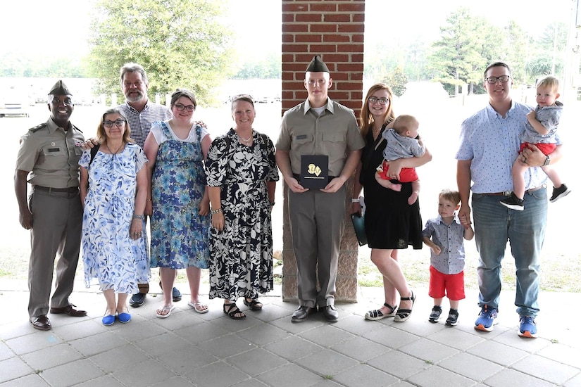 Pvt. Lukas Harris, center, a Pennsylvania Army National Guard recruit, poses with family members and Maj. Gen. Jason E. Kelly, left, commanding general, U.S. Army Training Center and Fort Jackson, South Carlina, following Harris' Basic Combat Training graduation June 27, 2024, at Fort Jackson. (Courtesy photo)