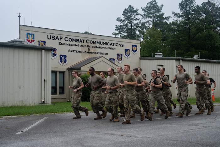A group of Airmen run in formation