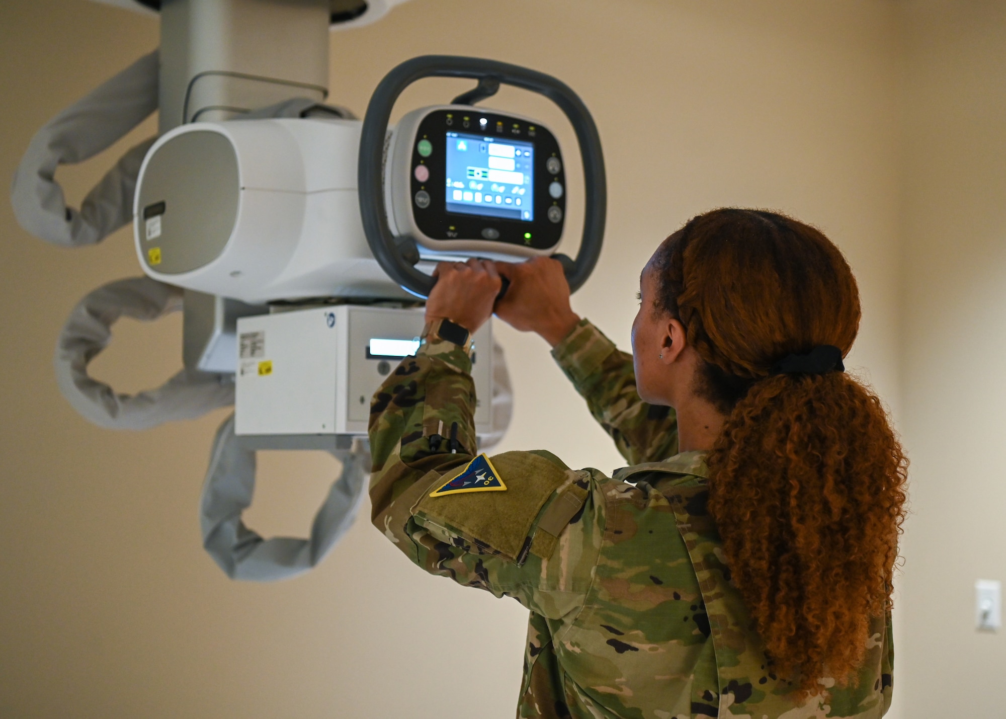 A 30th Medical Group diagnostic imaging technologist and winner of the 2024 Blacks in Government Meritorious Service Award, prepares the X-Ray radiography system for mandatory weekly training at Vandenberg Space Force Base.
